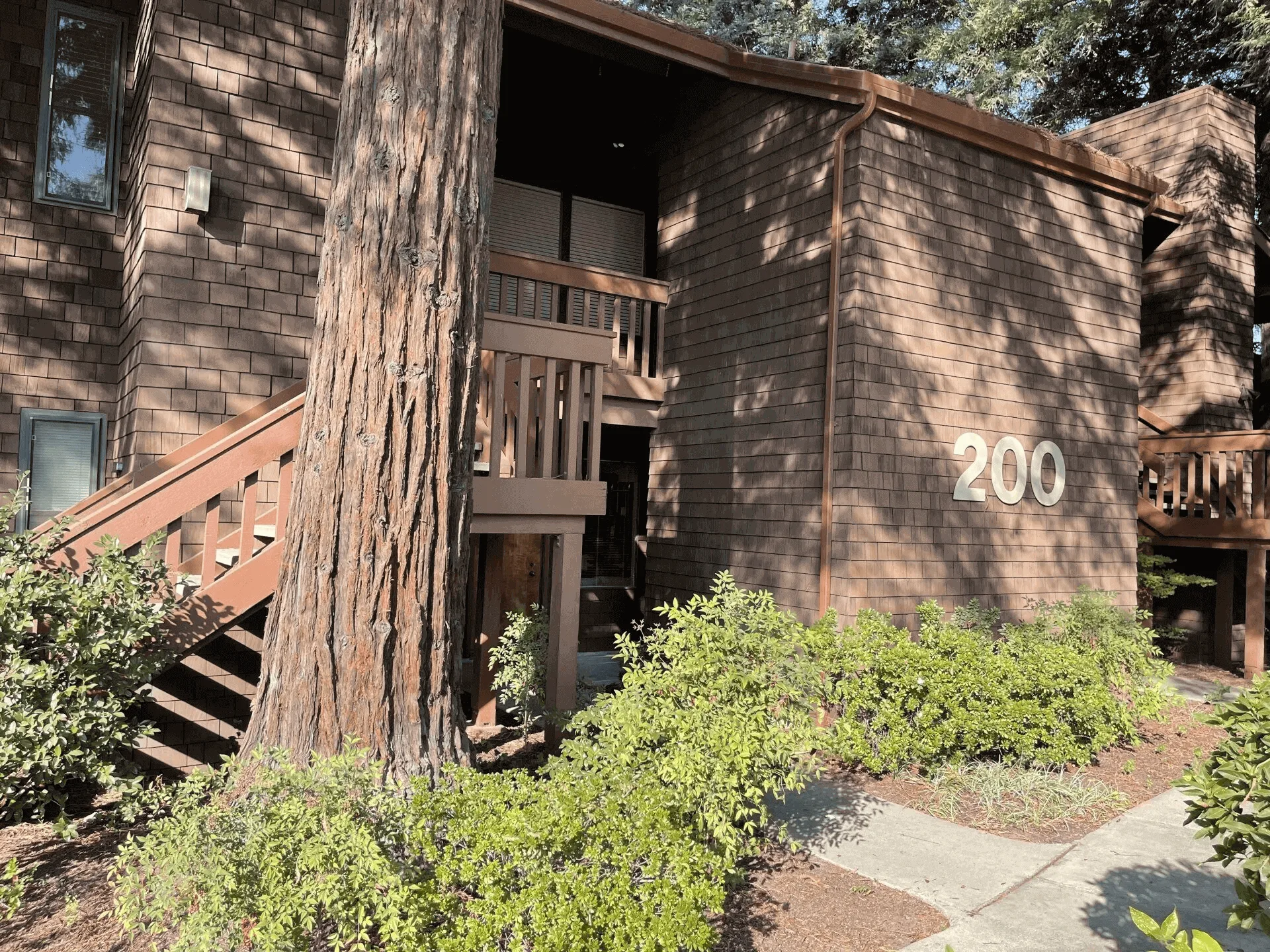 A building with stairs leading to the front door.