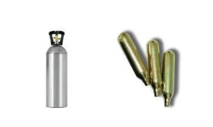 A silver cylinder and some green bullets