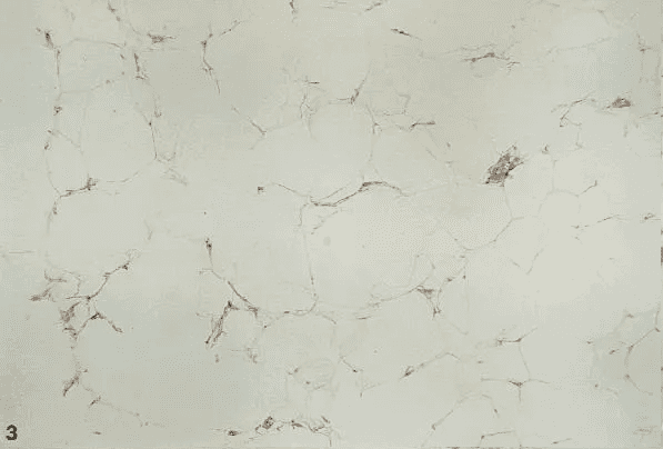 A white marble surface with some brown spots