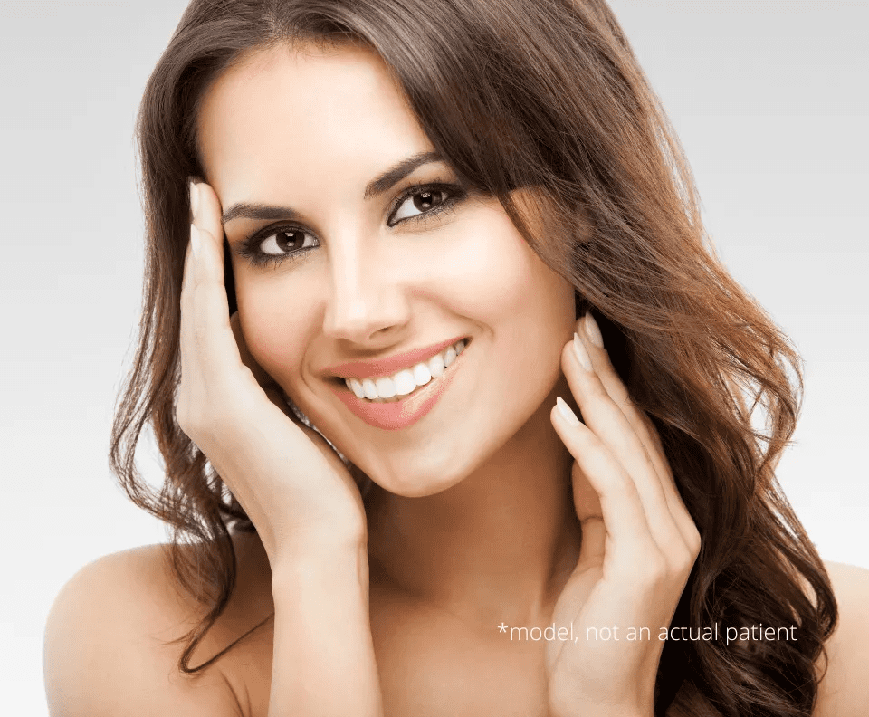 A beautiful woman with long brown hair posing for the camera.