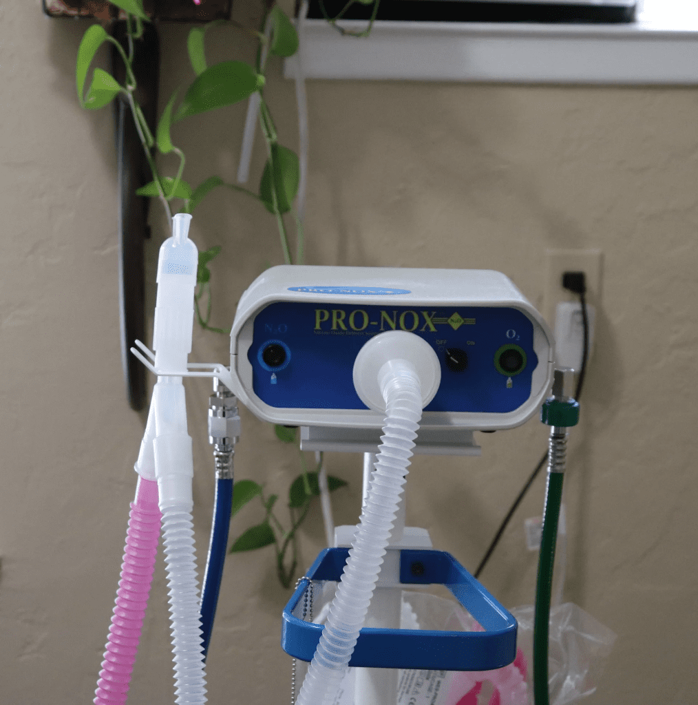 A blue and white machine with some pink tubes