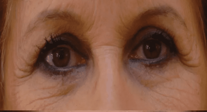 A woman 's eyes are shown with brown and black eye makeup.