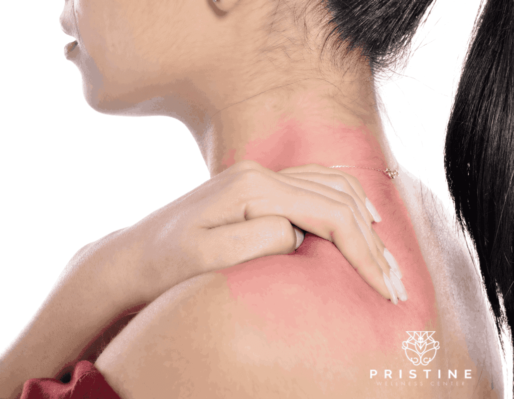 A woman with her hands on the back of her neck.