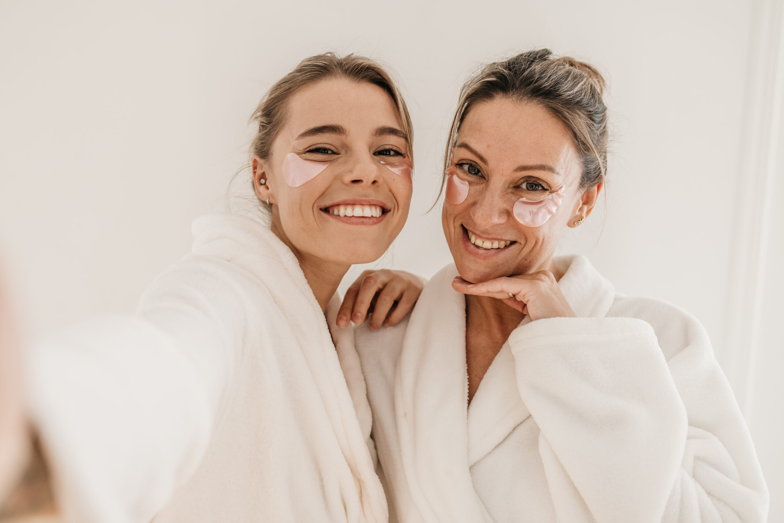 Two women in robes taking a selfie.